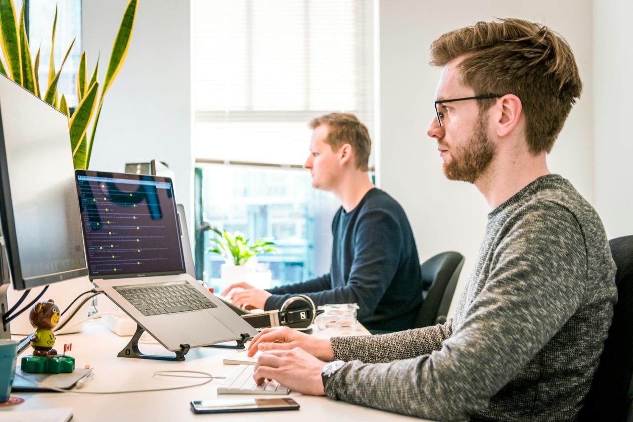 Support engineers monitoring devices at their workstations