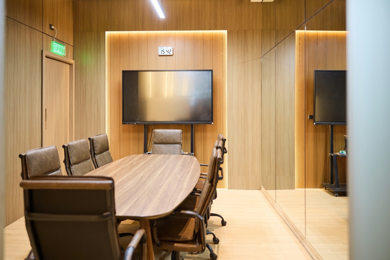 Modern boardroom with wood panelling and new video conferencing displays