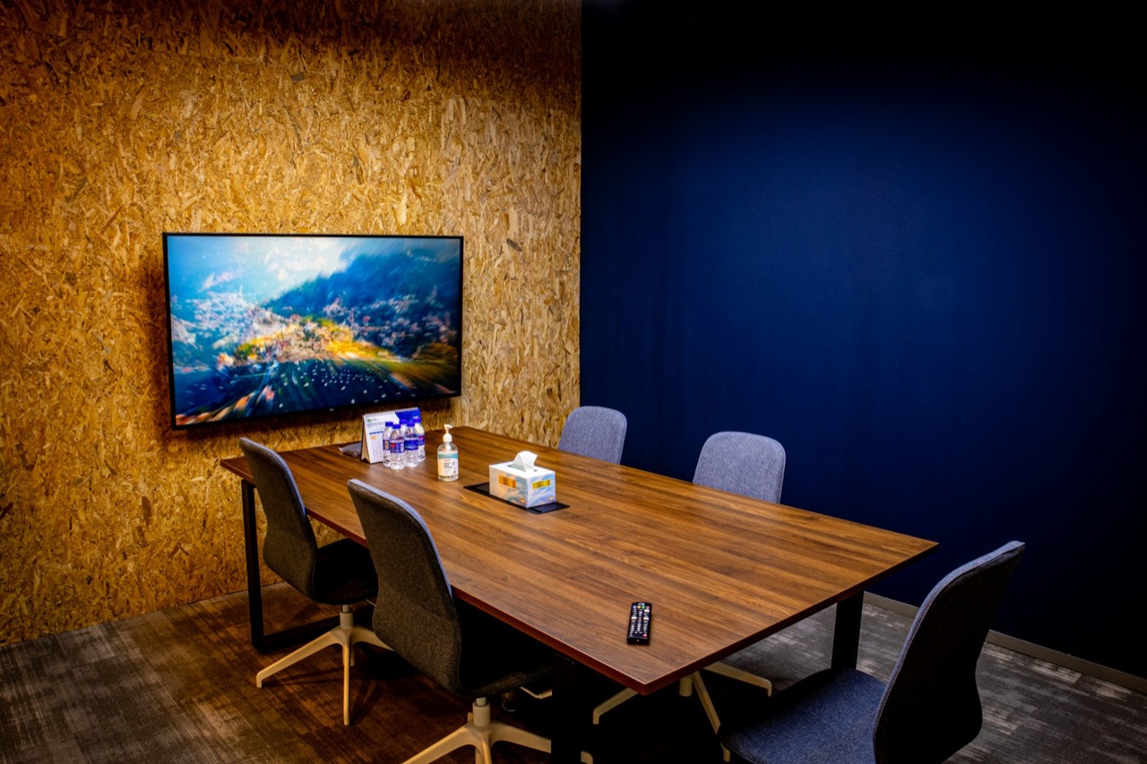 Meeting room with a wall-mounted display and conference table ready for an upgrade