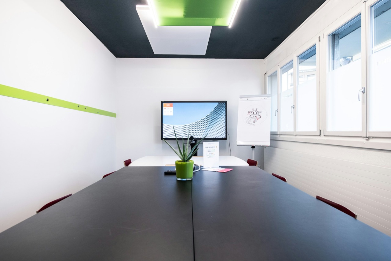 Meeting room with a wall-mounted display and conference table